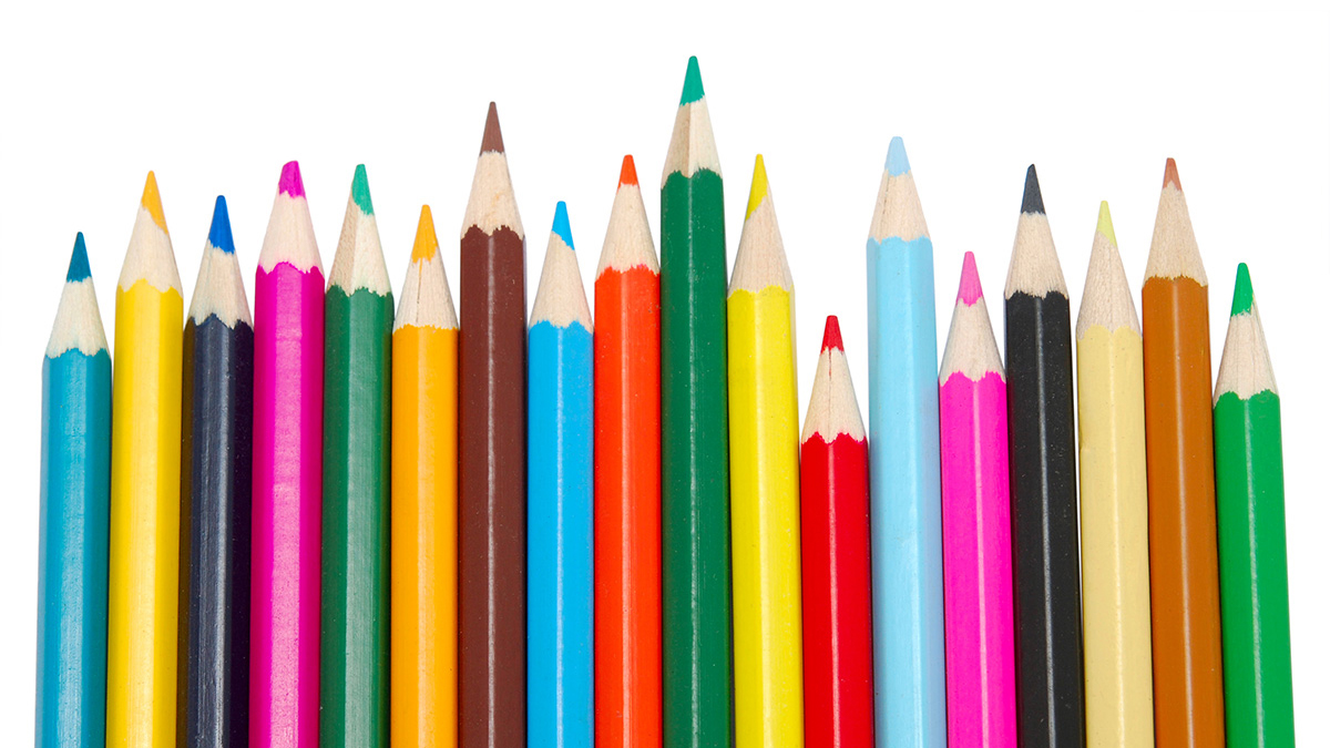 Brightly colored pencils lined up on a white background