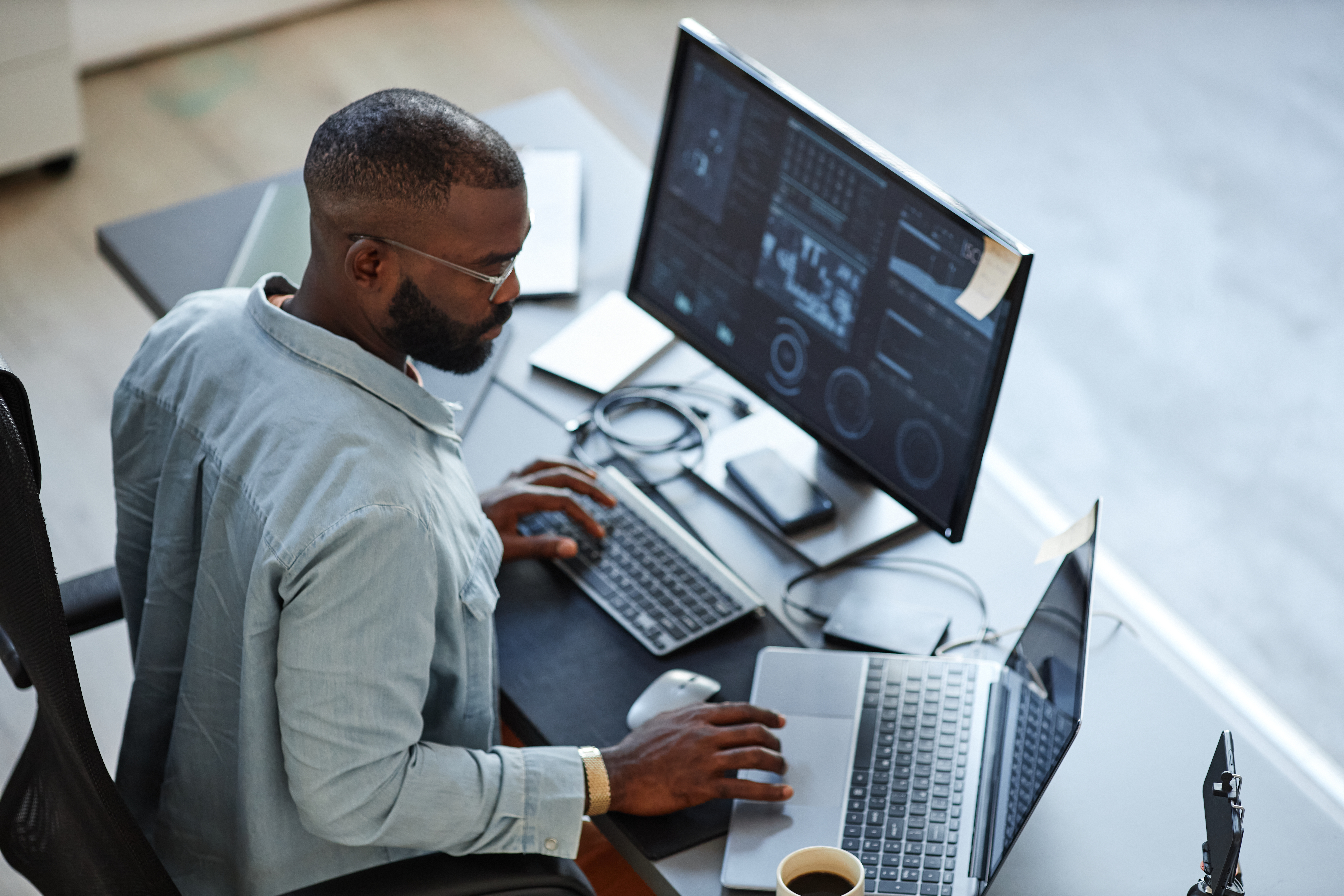 business analyst working with data on two screens