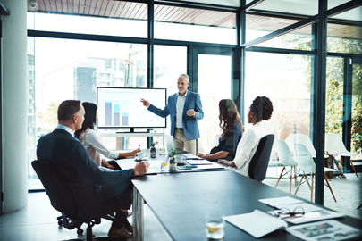 Group of professionals looking at data in boardroom