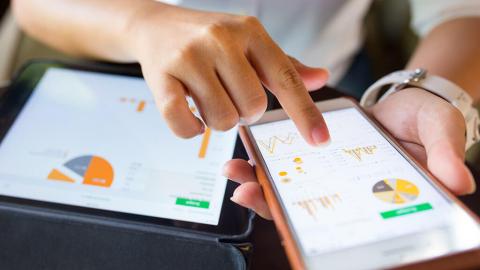 Woman accessing data charts on her smartphone