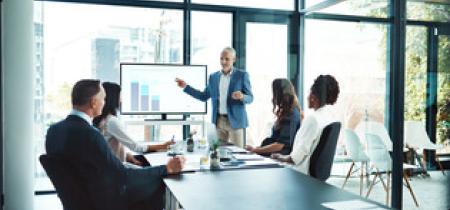 Group of professionals looking at data in boardroom